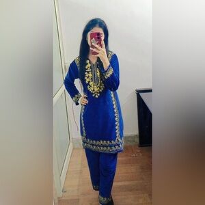 Blue velvet coord set with yellow embroidery.